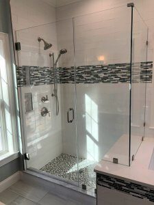 Frameless shower door panel shower enclosure with kneewall