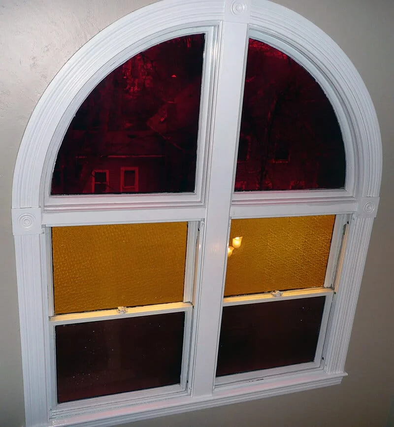 Protecting an arched window, saving energy, and staying warm in an older home.