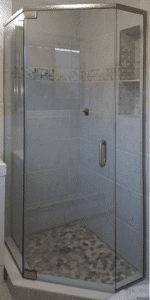 Semi frameless neo-angle shower incorporating pivot hinges on the door