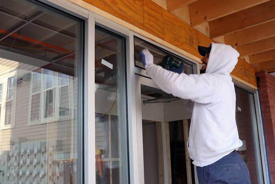 Pioneer Employee Installs Top Part of Storefront Exterior Door Pioneer Employee Installs Top Part of Storefront Exterior Door