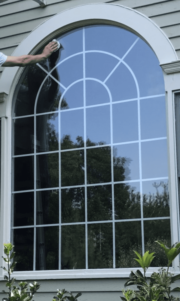 Replacement arched double pane window with grids.