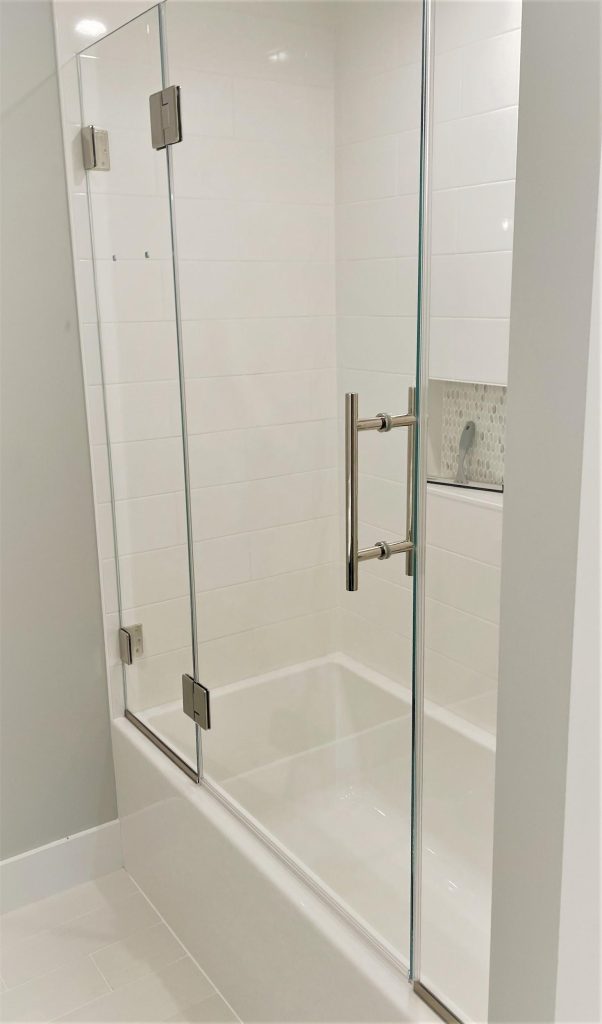 Centered glass bathtub doors offering symmetrical design.